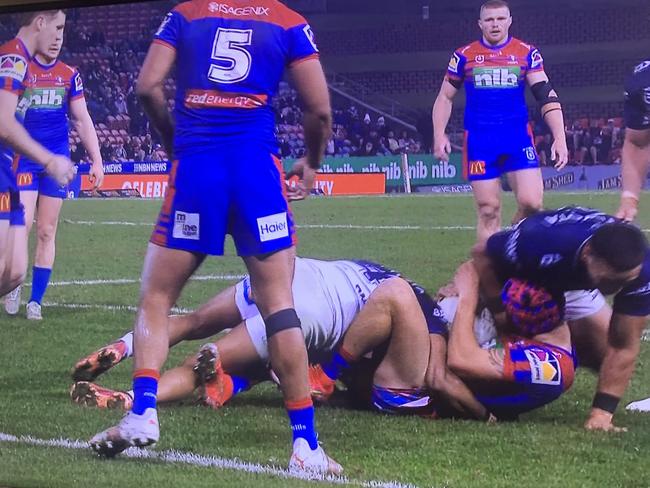 Knights fullback Kalyn Ponga a victim of potential crusher tackle from Cowboys’ Valentine Holmes.