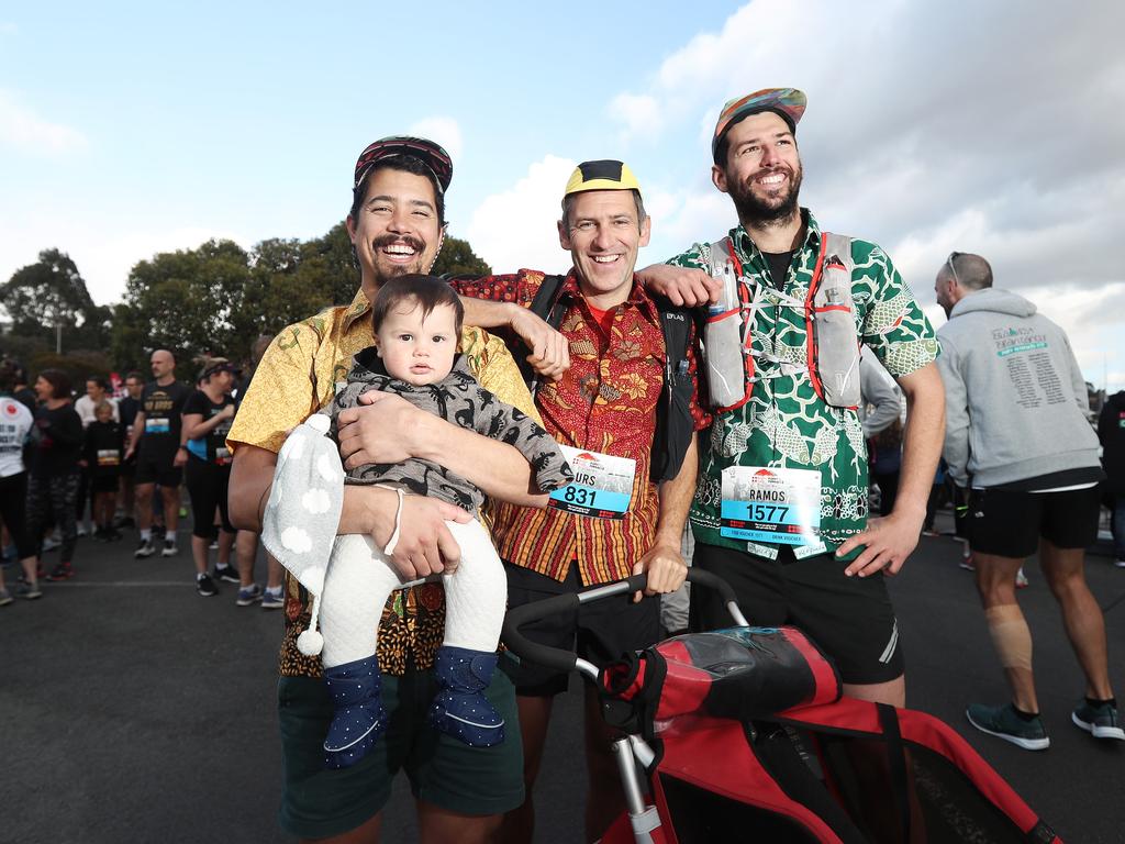 Akira Weller-Wong holding son Neko (left) with Urs Grueter and Rob Shaw at the 2019 Point to Pinnacle. Picture: LUKE BOWDEN