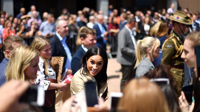 Meghan, the Duchess of Sussex, is all smiles as she meets with people outside the Opera House. Picture: Saeed Khan/AFP