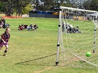 SCORE: A young player in the Under 12 Girls competition follows through after kicking the ball into the goal. Picture: Arthur Gorrie