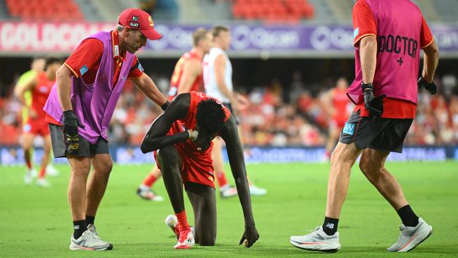 GOLD COAST, AUSTRALIA - FEBRUARY 28: Mac Andrew of the Suns receives attention on the field during the 2025 AAMI AFL Community Series match between Gold Coast Suns and Sydney Swans at People First Stadium on February 28, 2025 in Gold Coast, Australia. (Photo by Matt Roberts/AFL Photos/via Getty Images)