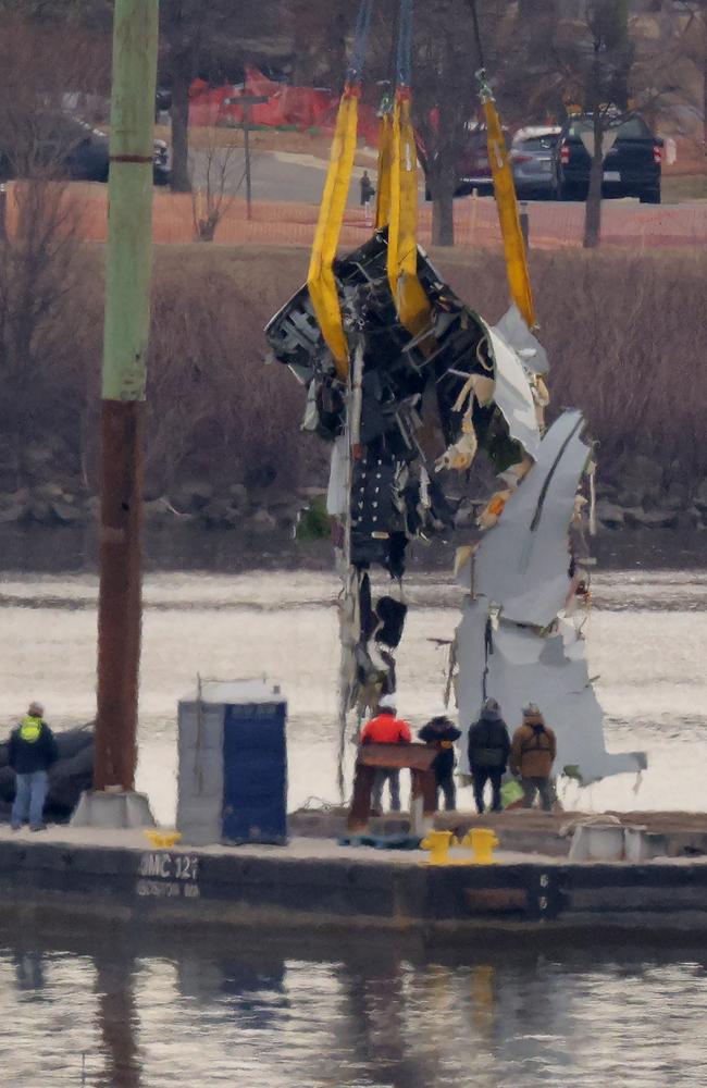 A large portion of the destroyed fuselage of American Airlines flight 5342 is lifted from the Potomac River. Picture: Getty Images