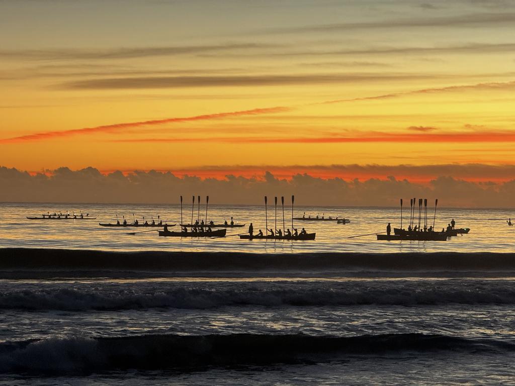 Molooloaba Surf Boats in a raised oar salute as part of the dawn service at Anzac Day 2024 at Mooloolaba which was attended by about 5000 people. Photo: Mark Furler