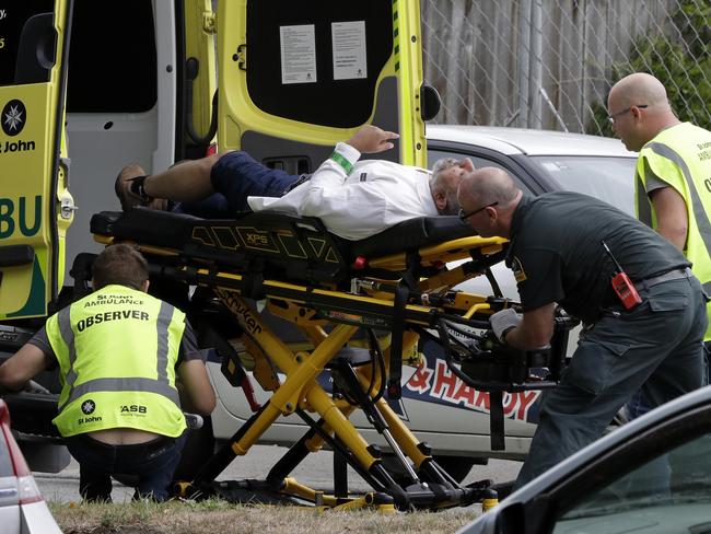 Ambulance staff take a man from outside a mosque in central Christchurch, New Zealand, Friday, March 15, 2019.  Multiple people were killed in mass shootings at two mosques full of worshippers attending Friday prayers on what the prime minister called "one of New Zealand's darkest days," as authorities detained four people and defused explosive devices in what appeared to be a carefully planned attack. (AP Photo/Mark Baker)