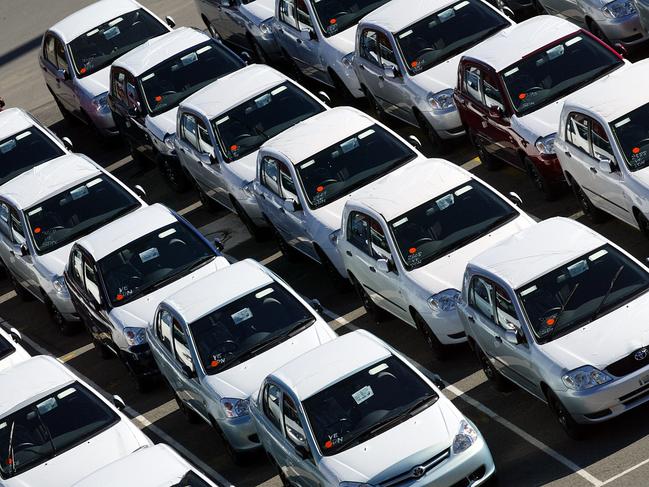 New cars sit ready to be delivered to dealers at Darling Harbour dock in Sydney, 19/05/2003.