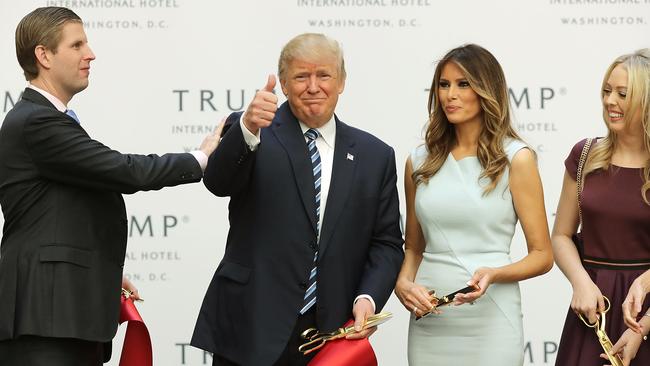 Donald Trump gives a thumbs up after cutting the ribbon at the new Trump International Hotel with his son Eric Trump (L), wife Melania Trump and daughter Tiffany Trump (R) in 2016 in Washington, DC.