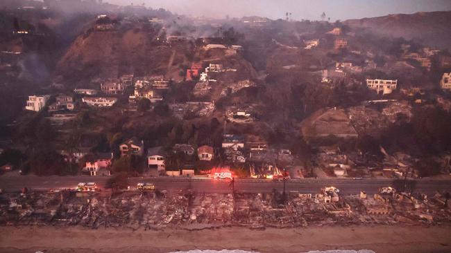 In an aerial view, destroyed homes are seen along the beach as the Palisades Fire continues to burn on January 09, 2025 in Malibu, California. Image: AFP