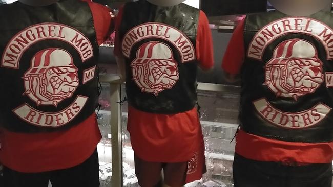 A trio of men believed to be affiliated with the North Queensland chapter flaunting their Mongrel Mob colours.