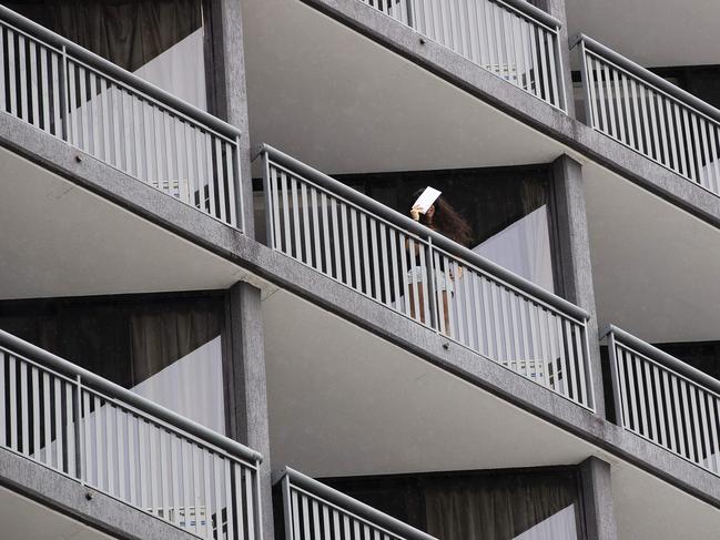 People looking out on balconies in quarantine hotel, Hotel Grand Chancellor where a cleaner tested positive for COVID-19. Greater Brisbane will go into to three-day hard lockdown from 6pm Friday. Hotel Grand Chancellor, 23 Leichhardt St, Brisbane City, Brisbane, 8th of January 2021. (News Corp/Attila Csaszar)