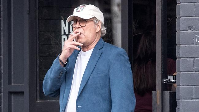 Chevy Chase smokes a cigarette on the set of the new Crocodile Dundee movie. Picture: Jake Nowakowski