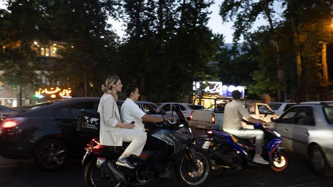Women, with their hair exposed to wind, are now a familiar sight aboard motorcycles in Tehran. Picture: Maryam Rahmanian/WSJ