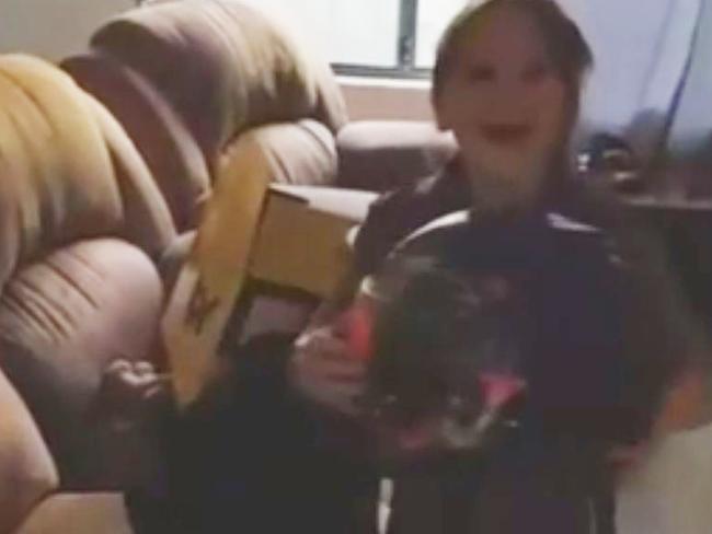 ‘Thank you, Daddy’: Anita unwraps her drag racing helmet, a significant gift for her eighth birthday last week. Picture: Channel 7