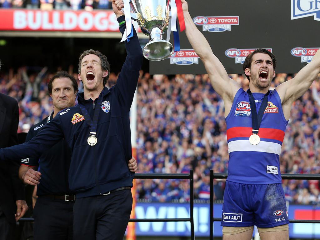 Luke Beverdige looks on as Bob Murphy and Easton Wood hold up the premiership cup in 2016. Picture: Michel Klein