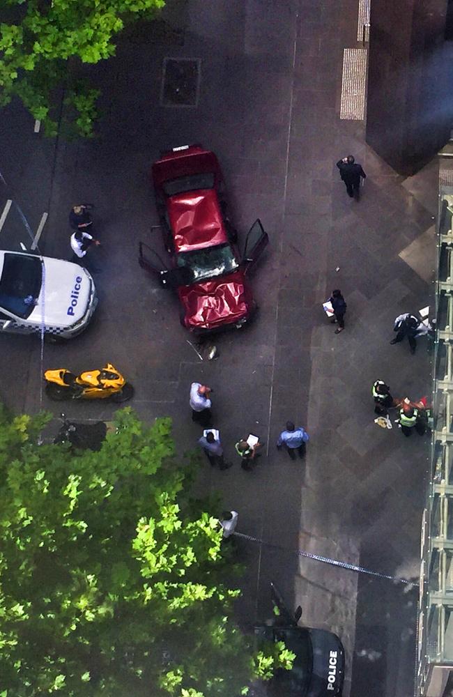 The wrecked car was surrounded by police and emergency services on the corner of Bourke and Elizabeth streets.