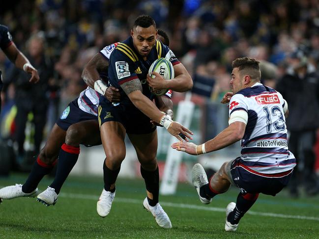 Tevita Li of the Highlanders fends off Tom English of the Rebels.