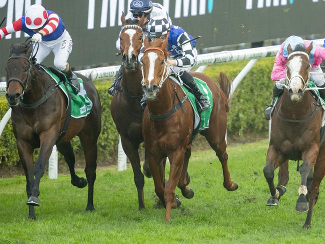 Kathy O'Hara (left) lifts Spaceboy over the line from the fast finishing Prairie Fire (right).