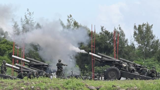 Taiwan military soldiers fire the 155-inch howitzers during a live fire anti landing drill. Picture: AFP.