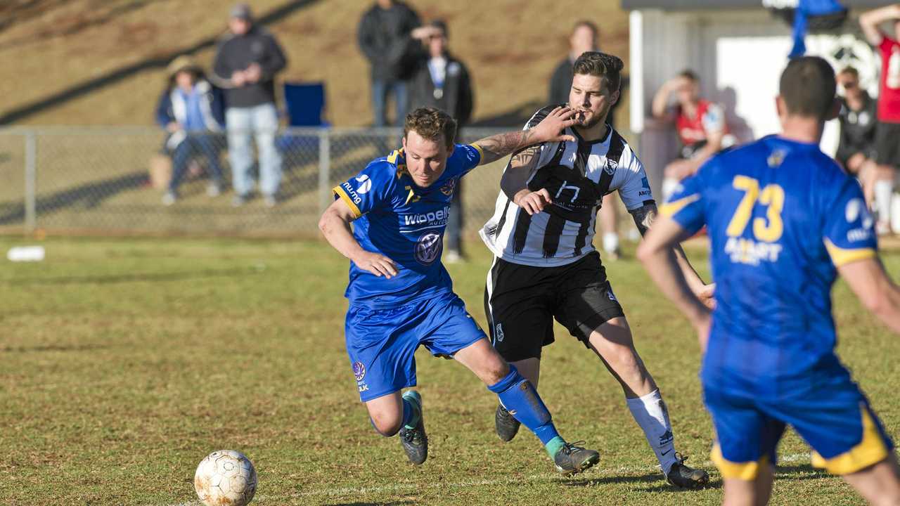 RIVALS: USQ's Ashley Freier (left) and Willowburn's Nathan Daly battle for possession. The two teams face-off in the Premier Men's grand final tomorrow at Clive Berghofer Stadium. Picture: Kevin Farmer