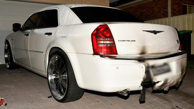 The Chrysler sedan belonging to a former Comanchero was damaged when at least two bombs were placed underneath it on Avery St, Rutherford on October 27, 2022. Picture: NSW Police.