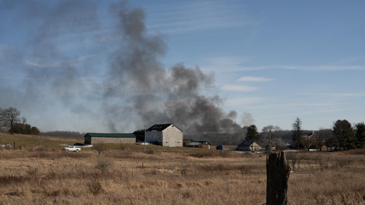 Smoke rises from a derailed cargo train in East Palestine Ohio, on February 4, 2023. - The train accident sparked a massive fire and evacuation orders, officials and reports said Saturday. No injuries or fatalities were reported after the 50-car train came off the tracks late February 3 near the Ohio-Pennsylvania state border. The train was shipping cargo from Madison, Illinois, to Conway, Pennsylvania, when it derailed in East Palestine, Ohio. (Photo by DUSTIN FRANZ / AFP)