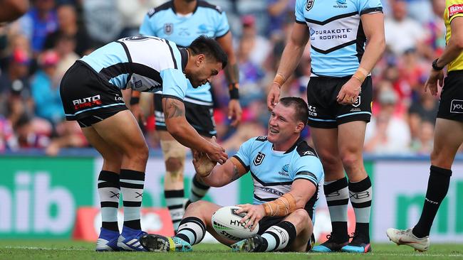 Et tu, Gal? Shaun Johnson gives Paul Gallen a helping hand. Picture: Getty