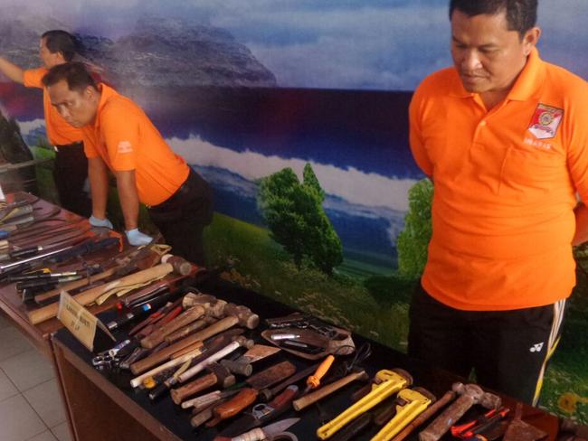 Violent intent ... officers survey the secret stash of weapons found inside the prison. Picture: Supplied