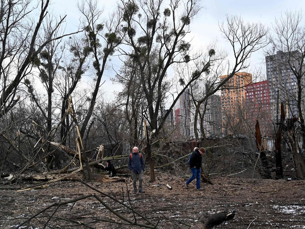 Members of the public walk among broken trees as a result of Russian missile strikes to the Ukrainian capital of Kyiv. Picture: AFP