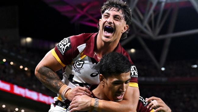 BRISBANE, AUSTRALIA - MAY 17: KotoniÃÂ Staggs of the Broncos jumps on Deine Mariner of the Broncos as they celebrate DeineÃÂ Mariner scoring a try during the round 11 NRL match between Manly Sea Eagles and Brisbane Broncos at Suncorp Stadium, on May 17, 2024, in Brisbane, Australia. (Photo by Hannah Peters/Getty Images)