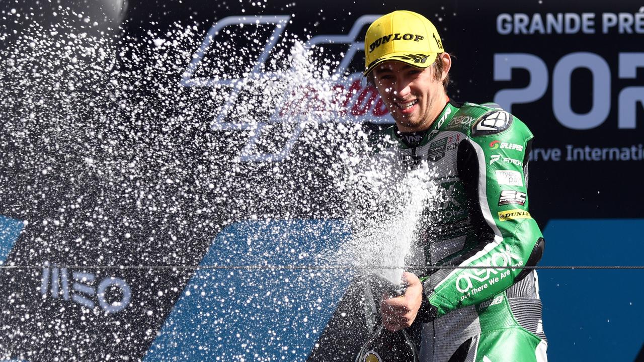 Remy Gardner celebrates on the podium (Photo by PATRICIA DE MELO MOREIRA / AFP)