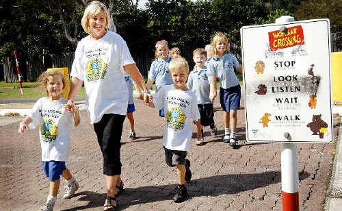 Byron Bay Public School kindy teacher Tracey Barnes, with Iliana Gelagotis, 5, (front left) and Ralph Hoult, 5, participating in the National Walk Safely to School Day. . Picture: DAVID NIELSEN