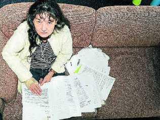 Christine Anderson with some of the documentation related to the auction of her home after payment of her land rates had lapsed. 