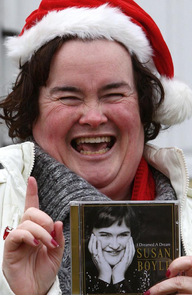Susan Boyle holds her best-selling album outside her home in Blackburn, Scotland in 2009. Picture: AP Photo/PA, Andrew Milligan