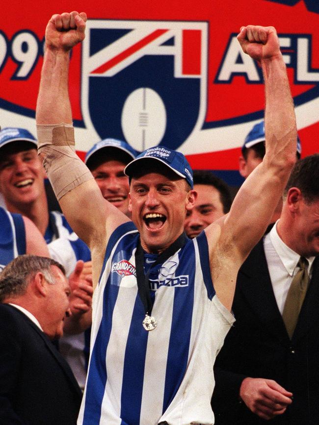 John Longmire receives his premiership medal after North Melbourne beat Carlton in the 1999 Grand Final.