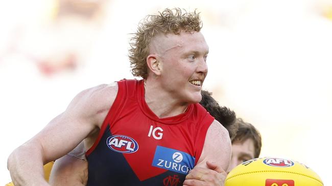 MELBOURNE, AUSTRALIA - MARCH 23: Clayton Oliver of the Demons handballs during the round two AFL match between Hawthorn Hawks and Melbourne Demons at Melbourne Cricket Ground, on March 23, 2024, in Melbourne, Australia. (Photo by Darrian Traynor/Getty Images)