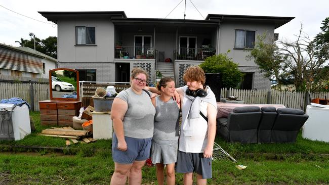 Wednesday February 13. Heavy rain causes flooding in North Queensland. Clean up after flooding in Ingham. Gabrielle Bube with daughter Davina Bube and son Kyren Riesenweb outside their unit which was inundated by floodwater. Picture: Evan Morgan