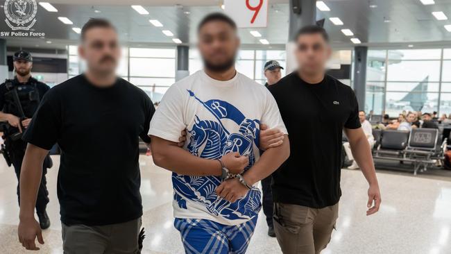 Paea Tuiniua being escorted through Sydney airport. Picture: NSW Police.