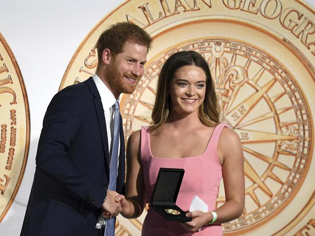 Britain's Prince Harry, left, presents the Young Adventurer of the Year award to Jade Hameister. Picture: AP