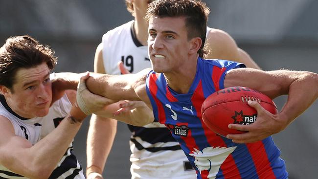 Nick Daicos fends off Josh Ward. Picture: Michael Klein