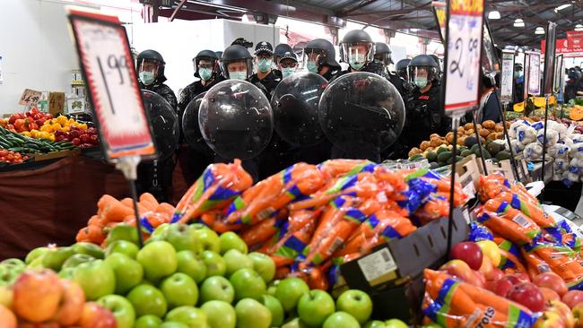 Riot police clear Melbourne's Queen Victoria Market of anti-lockdown protesters on Sunday. Picture: AFP