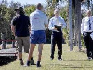 No bids: Ray White Banora principal Gary Teis (facing in blue shirt) and sales and marketing specialist David Powell look for bidders at yesterday’s auction at the Ballina Fishing Park. . Picture: Jay Cronan