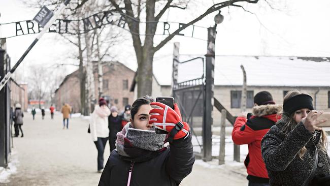 Visitors take selfies at the Auscwitz-Birkenau concentration camp.