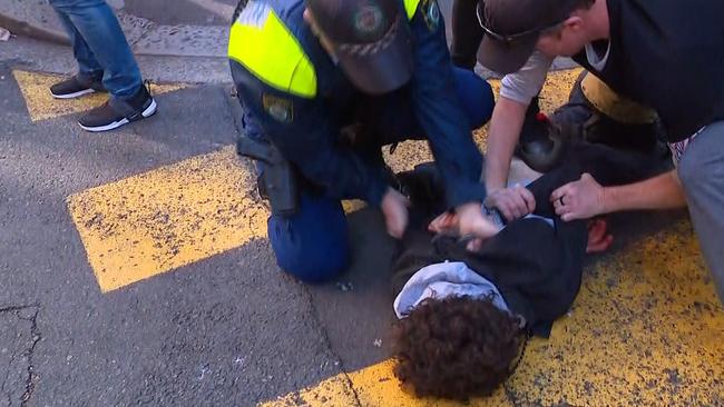 Bystanders help police make an arrest. Picture: Seven News