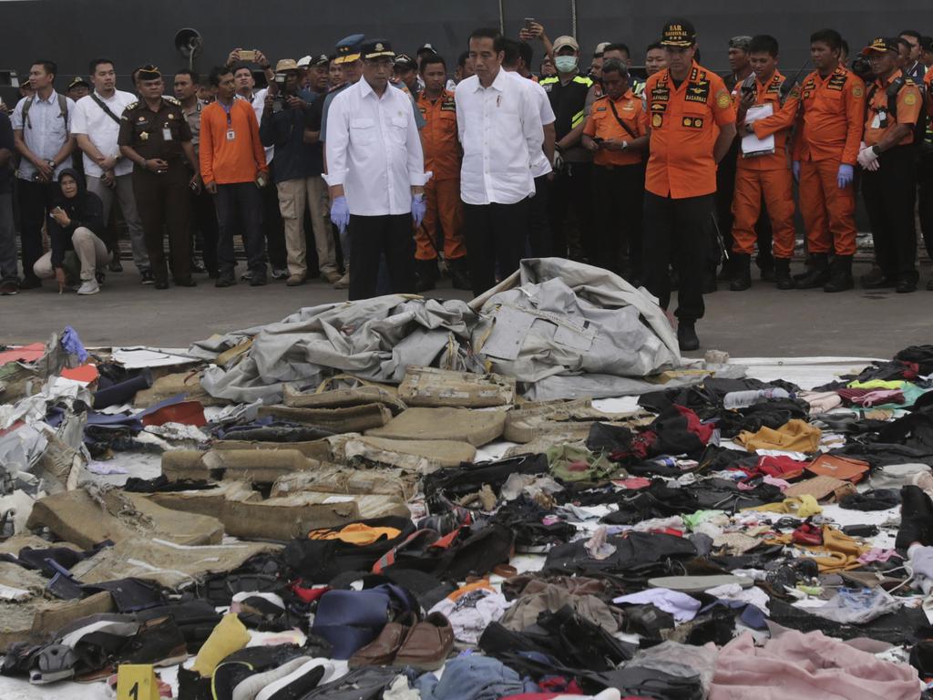 Indonesian President Joko Widodo, centre, inspects debris pulled from the Lion Air plane’s crash site. Picture: AP/Binsar Bakara