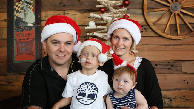 Jax Dixon, 3, prepares for the fundraiser with parents Adam and Kylie and sister Amelia, 8 months. Pictures: Robert Pozo