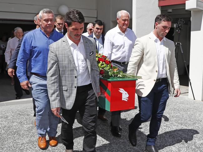 BRISBANE, AUSTRALIA - NewsWire Photos MARCH 31, 2023: Grand children Blake Scott and Jack Sattler, front, Troy McCarthy, and Ron Coote with the casket during the funeral for Souths legend John Sattler on the Gold Coast. Picture: NCA NewsWire/Tertius Pickard