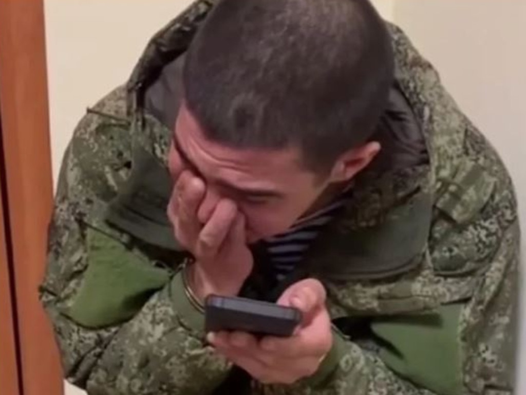 A Russian soldier weeps after being captured in Ukraine.