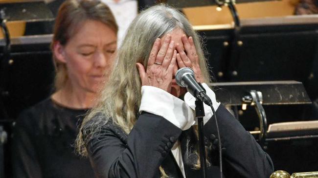 US singer Patti Smith covers her face when performing 'A Hard Rain's A-Gonna Fall' by absent 2016 Nobel literature laureate Bob Dylan during the 2016 Nobel prize award ceremony at the Stockholm Concert Hall on Saturday Dec. 10, 2016. (Jonas Ekstromer/TT News Agency via AP). Picture: Jonas Ekstromer