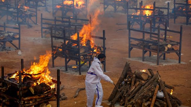 A man performs the last rites of a deceased relative in a disused granite quarry in India. Picture: Abhishek Chinnappa/Getty