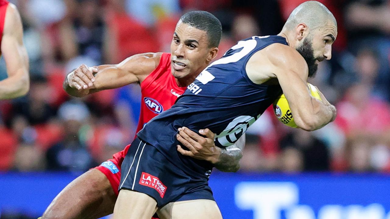 Adam Saad is tackled by Touk Miller. Picture: AFL Photos via Getty Images