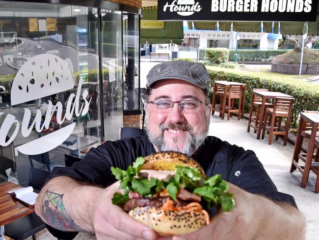 Burger Hounds owner James Ballingall holds his 'Bun Mi' burger creation that includes Julianne's Kitchen chicken patŽ at Wahroonga on Tuesday September 4th. Chef Julianne Lever runs a pates/terrines/fruit paste business in Hornsby called Julianne's Kitchen which has been selected by the NSW Department of Industries to represent them at the Fine Foods Show in Melbourne later this month, and they supply pate used in the high-end burgers at Burger Hounds. (AAP IMAGE / Troy Snook)